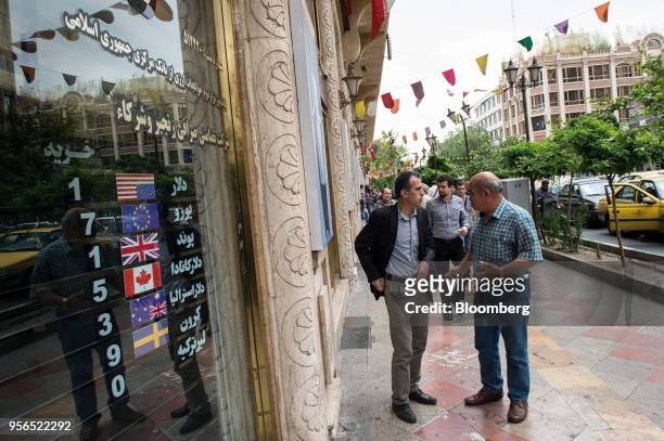 Pedestrians stop and talk outside a closed currency exchange bureau in Tehran, Iran, on Wednesday, May 9, 2018. U.S. President Donald Trump pulled...