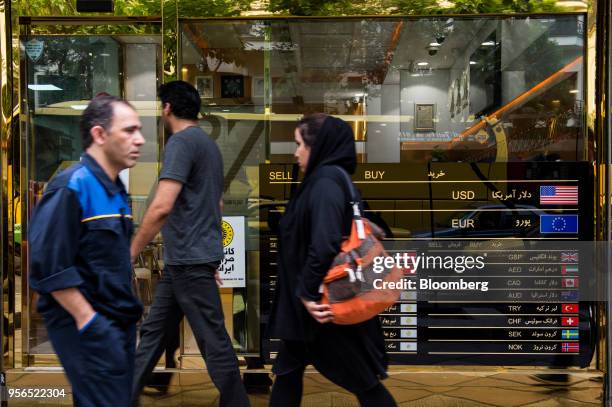 Pedestrians pass a closed currency exchange bureau in Tehran, Iran, on Wednesday, May 9, 2018. U.S. President Donald Trump pulled out of the 2015...