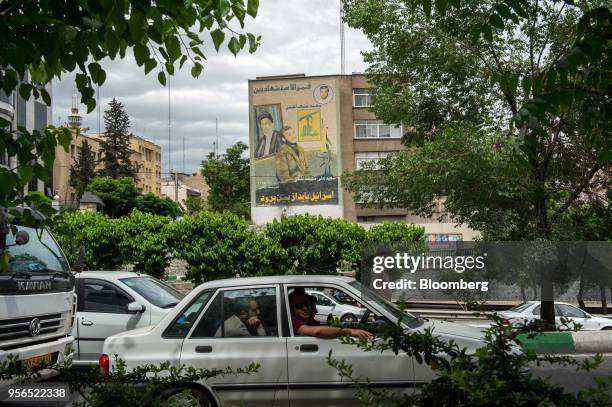 Commuters drive past a giant wall mural proclaiming the destruction of Israel following a U.S. Withdrawal from the nuclear deal in Tehran, Iran, on...