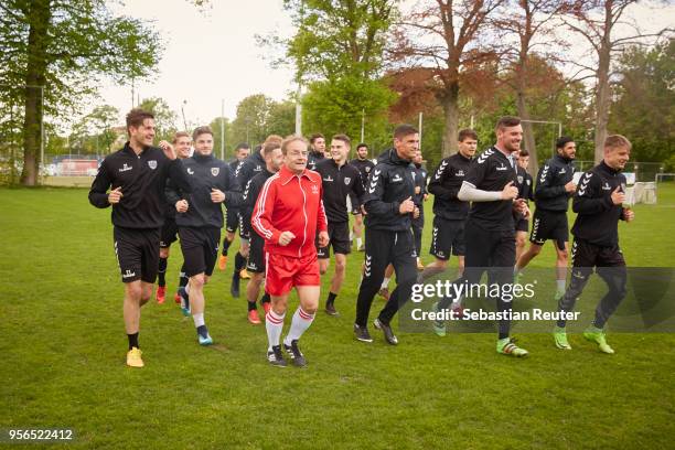 Wigald Boning is seen on set with players of SV Babelsberg 03 during the shooting for the new documentary 'Deutschland - Deine Fussballseele' by the...