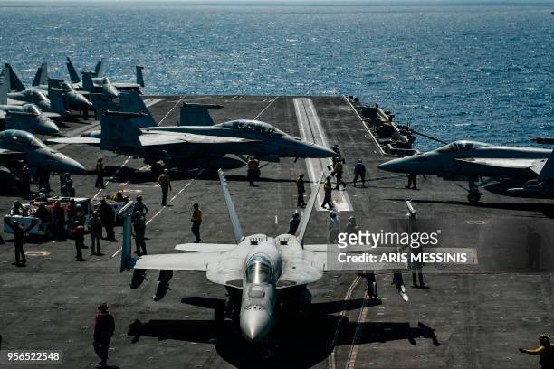An F18 Hornet fighter jet moves on the deck of the 330 meters navy aircraft carrier USS Harry S. Truman in the eastern Mediterranean Sea on May 8,...