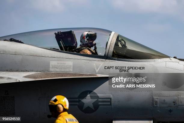 An F18 Hornet fighter jet pilot waits to take off from the 330 meters aircraft carrier USS Harry S. Truman in the eastern Mediterranean Sea on May 8,...