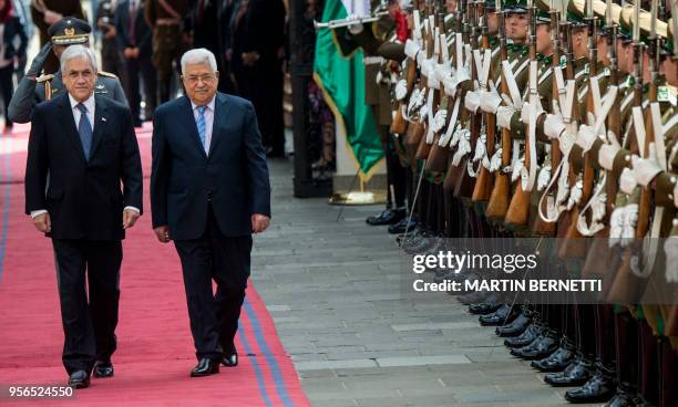 Chilean President Sebastian Pinera and Palestinian President Mahmud Abbas, review the honour guard, during Abbas' welcome ceremony at La Moneda...