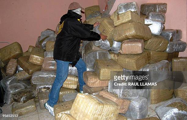 Policeman piles packages of confiscated marijuana in Nuevo Laredo, Tamaulipas state, Mexico, in the border with the United States on January 8, 2010....