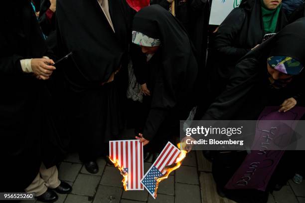 Iranian women burn American flags during an anti-U.S. Demonstration outside the former U.S. Embassy headquarters in Tehran, Iran, on Wednesday, May...