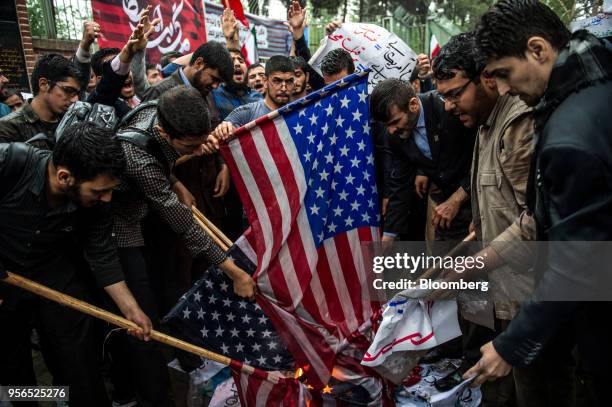 Iranians prepare to burn American flags during an anti-U.S. Demonstration outside the former U.S. Embassy headquarters in Tehran, Iran, on Wednesday,...