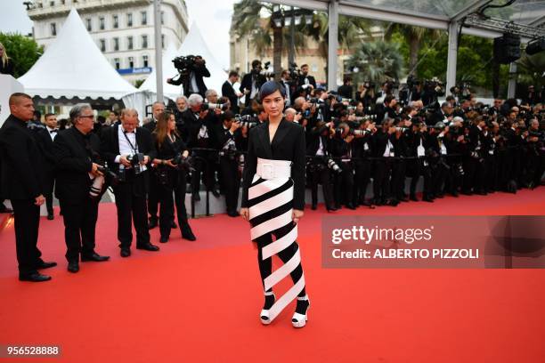 Chinese actress and singer Li Yuchun poses as she arrives on May 9, 2018 for the screening of the film "Yomeddine" at the 71st edition of the Cannes...