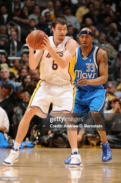 Adam Morrison of the Los Angeles Lakers moves the ball against James Singleton of the Dallas Mavericks during the game on January 3, 2010 at Staples...