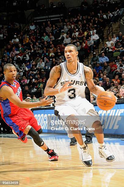 George Hill of the San Antonio Spurs moves the ball against Sebastian Telfair of the Los Angeles Clippers during the game on December 21, 2009 at the...