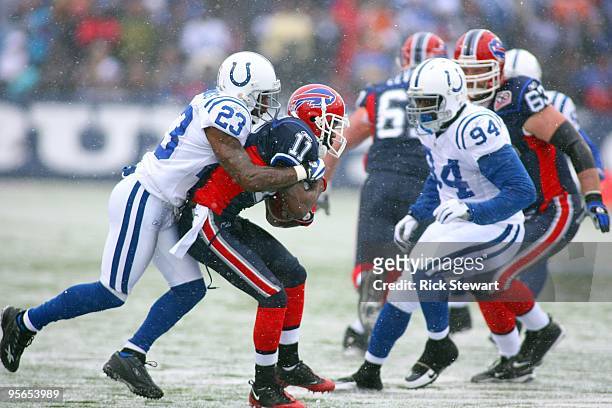 Tim Jennings of the Indianapolis Colts tackles Roscoe Parrish of the Buffalo Bills during their NFL game at Ralph Wilson Stadium on January 3, 2010...