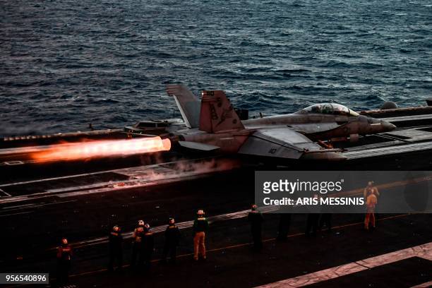 Hornet fighter jet pilot takes off from the deck of the US navy aircraft carrier USS Harry S. Truman in the eastern Mediterranean Sea on May 8, 2018....