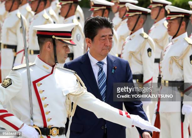 Japanese Prime Minister Shinzo Abe reviews the honor guards at the Defense Ministry in Tokyo on September 11, 2017. Abe and Defense Minister Itsunori...