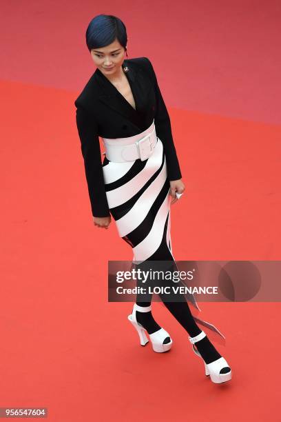 Chinese actress and singer Li Yuchun poses as she arrives on May 9, 2018 for the screening of the film "Yomeddine" at the 71st edition of the Cannes...