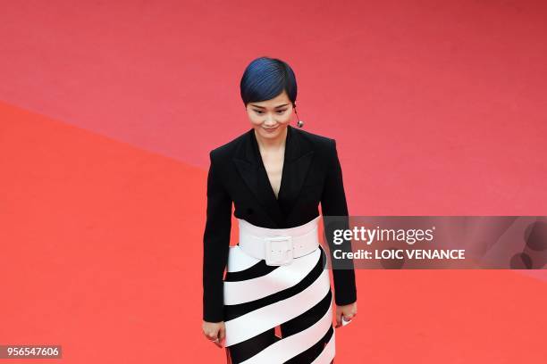 Chinese actress and singer Li Yuchun poses as she arrives on May 9, 2018 for the screening of the film "Yomeddine" at the 71st edition of the Cannes...