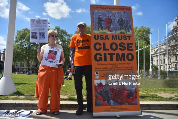 Demonstrators wear the iconic orange prisoner's uniform as they demonstrate outside the Parliament asking for Guantanamo prison to be closed, London...