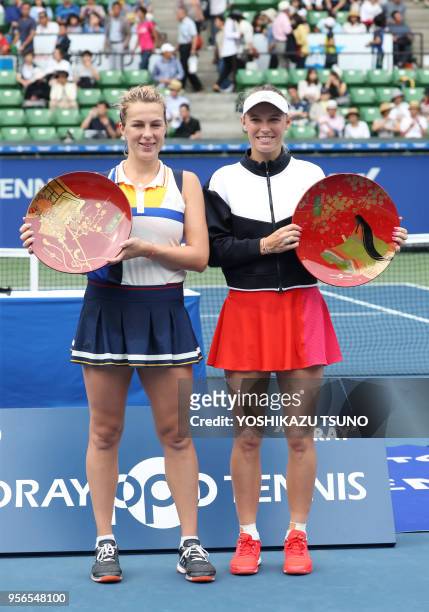 La joueuse de tennis danoise Caroline Wozniacki soulevant son trophée après sa victoire en finale, et la joueuse de tennis russe Anastasia...