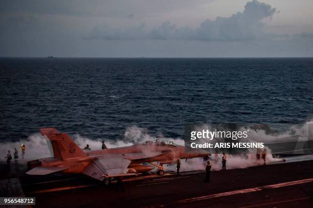 Hornet fighter jet waits to take off from the deck of the 330 meters US navy aircraft carrier the USS Harry S. Truman in the eastern Mediterranean...
