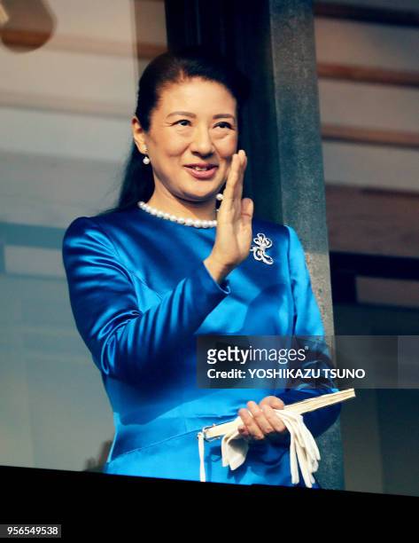 Japanese Crown Princess Masako waves to well-wishers gathered for the annual New Year's greetings at the Imperial Palace in Tokyo on January 2, 2017....