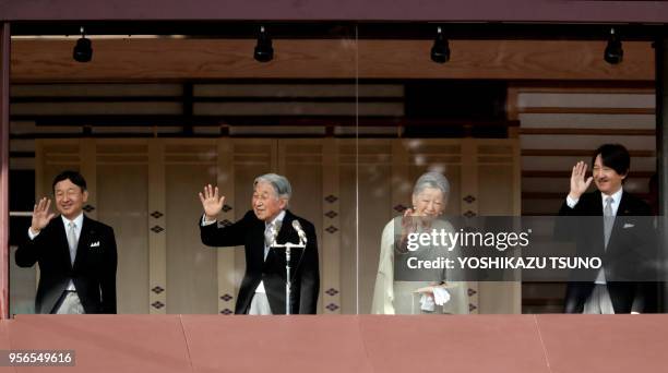 Japanese Emperor Akihito , accompanied by Empress Michiko , Crown Prince Naruhito and Prince Akishino waves to well-wishers gathered for the annual...