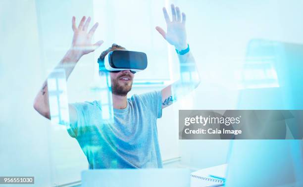 male computer programmer testing virtual reality simulator glasses in office - software programmer stock pictures, royalty-free photos & images