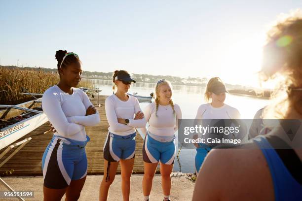 female rowers meeting at sunny lakeside - sculling crew stock pictures, royalty-free photos & images