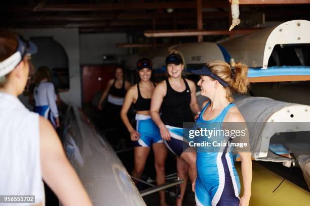 female rowing team preparing in boathouse - sculling crew stock pictures, royalty-free photos & images