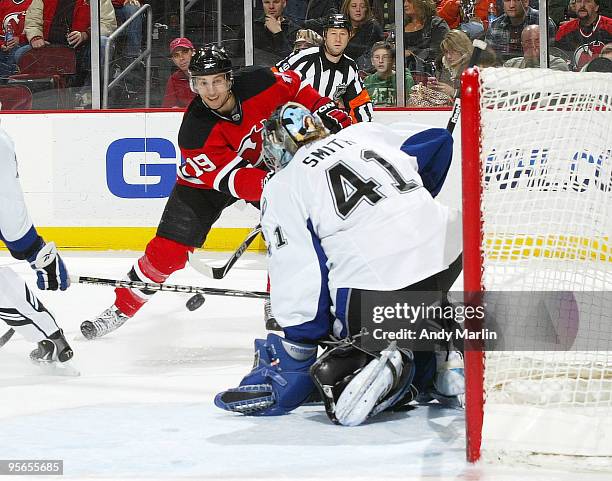 Goaltender Mike Smith of the Tampa Bay Lightning defends his net as Travis Zajac of the New Jersey Devils fires a shot during their game at the...