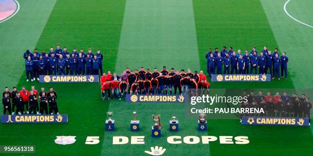 Barcelona's hockey, basketball, football, futsal and handball champions pose for a group picture behind their trophies ahead of the Spanish league...