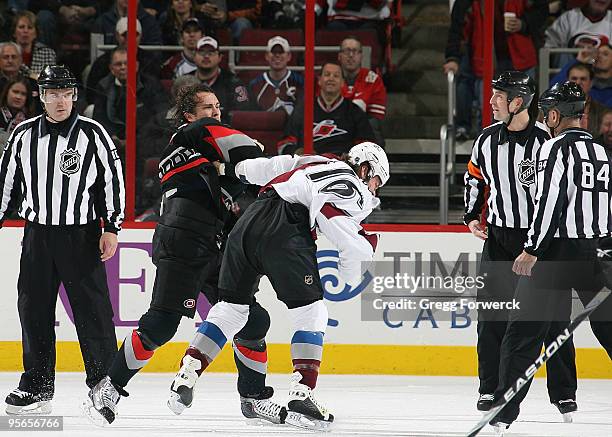 Tuomo Ruutu of the Carolina Hurricanes and Darcy Tucker of the Colorado Avalanche receive five minute majors for a fight during an NHL game on...
