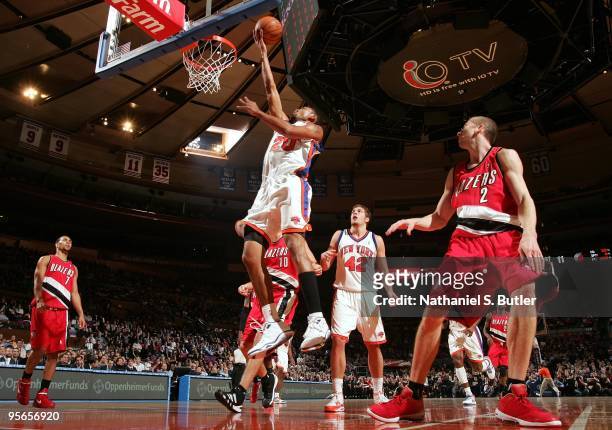 Jared Jeffries of the New York Knicks shoots a layup against Steve Blake of the Portland Trail Blazers during the game at Madison Square Garden on...