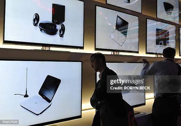 An attendee examines Infinia Live Borderless television display at the LG booth at the 2010 International Consumer Electronics Show, January 8, 2010...