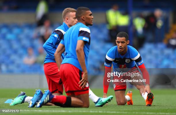 Tom Ince of Huddersfield Town warms up prior to the Premier League match between Chelsea and Huddersfield Town at Stamford Bridge on May 9, 2018 in...