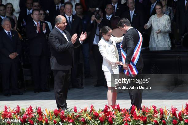 Outgoing President Luis Guillermo Solis applauds as Carolina Hidalgo President of the Congress gives newly elected President of Costa Rica Carlos...
