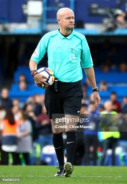 Referee Lee Mason walks out with the match ball prior to the Premier League match between Chelsea and Huddersfield Town at Stamford Bridge on May 9,...