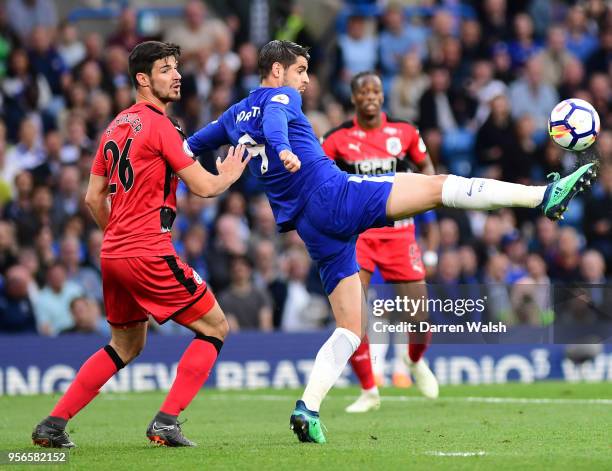 Christopher Schindler of Huddersfield Town looks on as Alvaro Morata of Chelsea controls the ball during the Premier League match between Chelsea and...