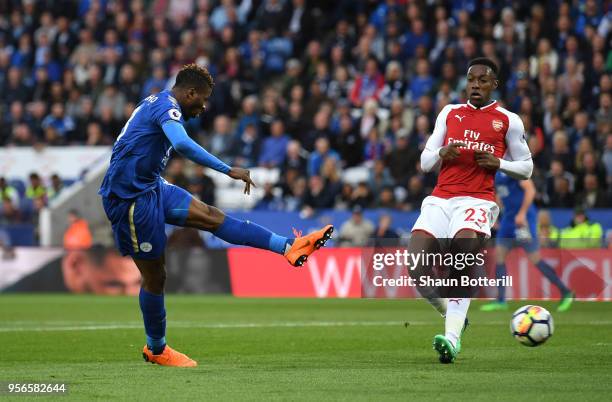 Kelechi Iheanacho of Leicester City scores his sides first goal as Danny Welbeck of Arsenal looks on during the Premier League match between...