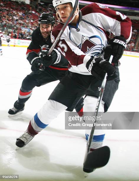 Chris Stewart of the Colorado Avalanche struggles with Niclas Wallin of the Carolina Hurricanes during an NHL game on January 8, 2010 at RBC Center...