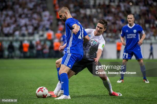 Kirill Gotsuk of FC Avangard competes with Vagiz Galiulin of FC Tosno during Russian Cup Final match between FC Tosno and Fc Avangard at Volgograd...