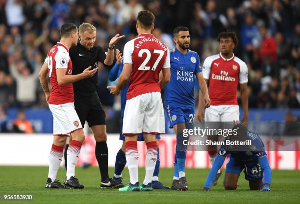 Granit Xhaka of Arsenal speaks with referee Graham Scott as Konstantinos Mavropanos of Arsenal appeals his innocent during the Premier League match...