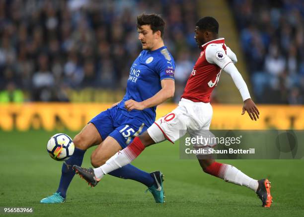 Harry Maguire of Leicester City is challenged by Ainsley Maitland-Niles of Arsenal during the Premier League match between Leicester City and Arsenal...