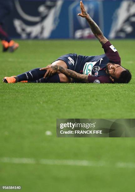 Paris Saint-Germain's Brazilian defender Daniel Alves gestures as he lies on the ground during the French Cup final football match between Les...