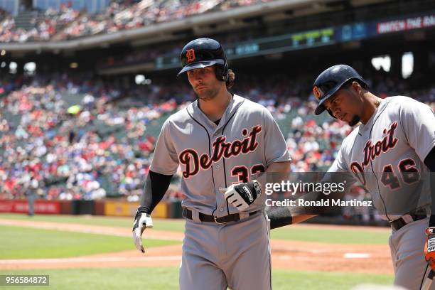 Pete Kozma of the Detroit Tigers celebrates a homerun with Jeimer Candelario of the Detroit Tigers in the third inning at Globe Life Park in...