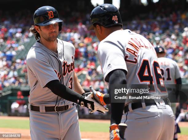 Pete Kozma of the Detroit Tigers celebrates a homerun with Jeimer Candelario of the Detroit Tigers in the third inning at Globe Life Park in...