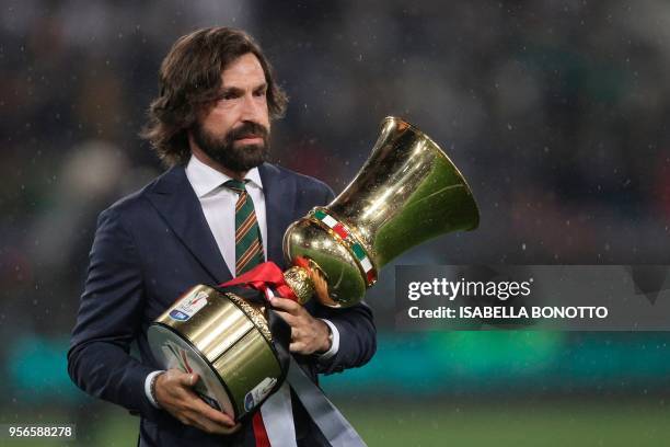 Former Italy's international player Andrea Pirlo holds the trophy before the Italian Tim Cup final Juventus vs AC Milan at the Olympic stadium on May...