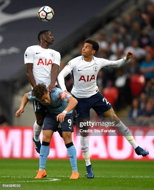 Victor Wanyama of Tottenham Hotspur wins a header over Dele Alli of Tottenam Hotspur and Dwight Gayle of Newcastle United during the Premier League...