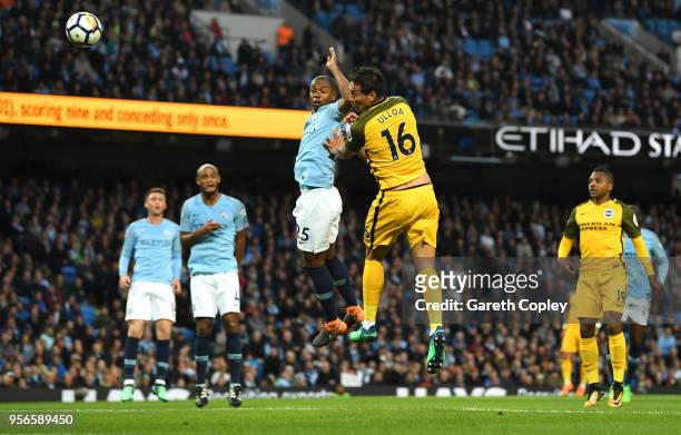Leonardo Ulloa of Brighton and Hove Albion scores his sides first goal as he wins a header over Fernandinho of Manchester City during the Premier...