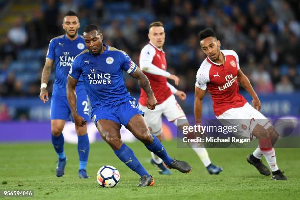 Wes Morgan of Leicester City takes the ball awy from Pierre-Emerick Aubameyang of Arsenal during the Premier League match between Leicester City and...
