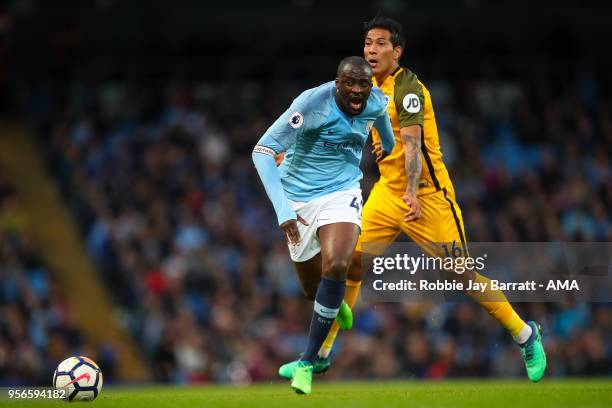 Yaya Toure of Manchester City and Leonardo Ulloa of Brighton & Hove Albion during the Premier League match between Manchester City and Brighton and...