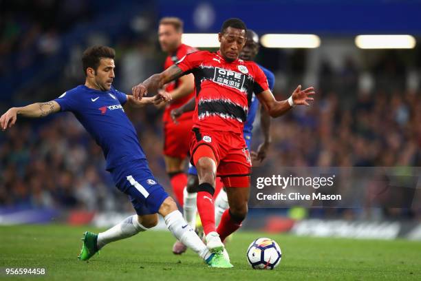 Cesc Fabregas of Chelsea battles for possession with Rajiv van La Parra of Huddersfield Town during the Premier League match between Chelsea and...