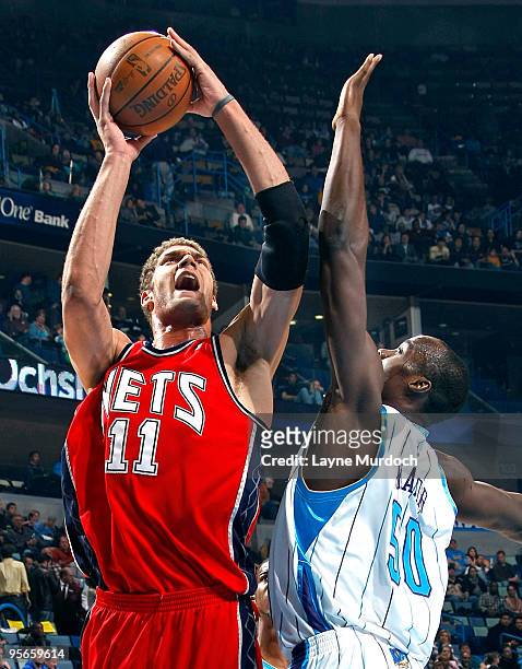 Brook Lopez of the New Jersey Nets shoots over Emeka Okafor of the New Orleans Hornets on January 8, 2010 at the New Orleans Arena in New Orleans,...